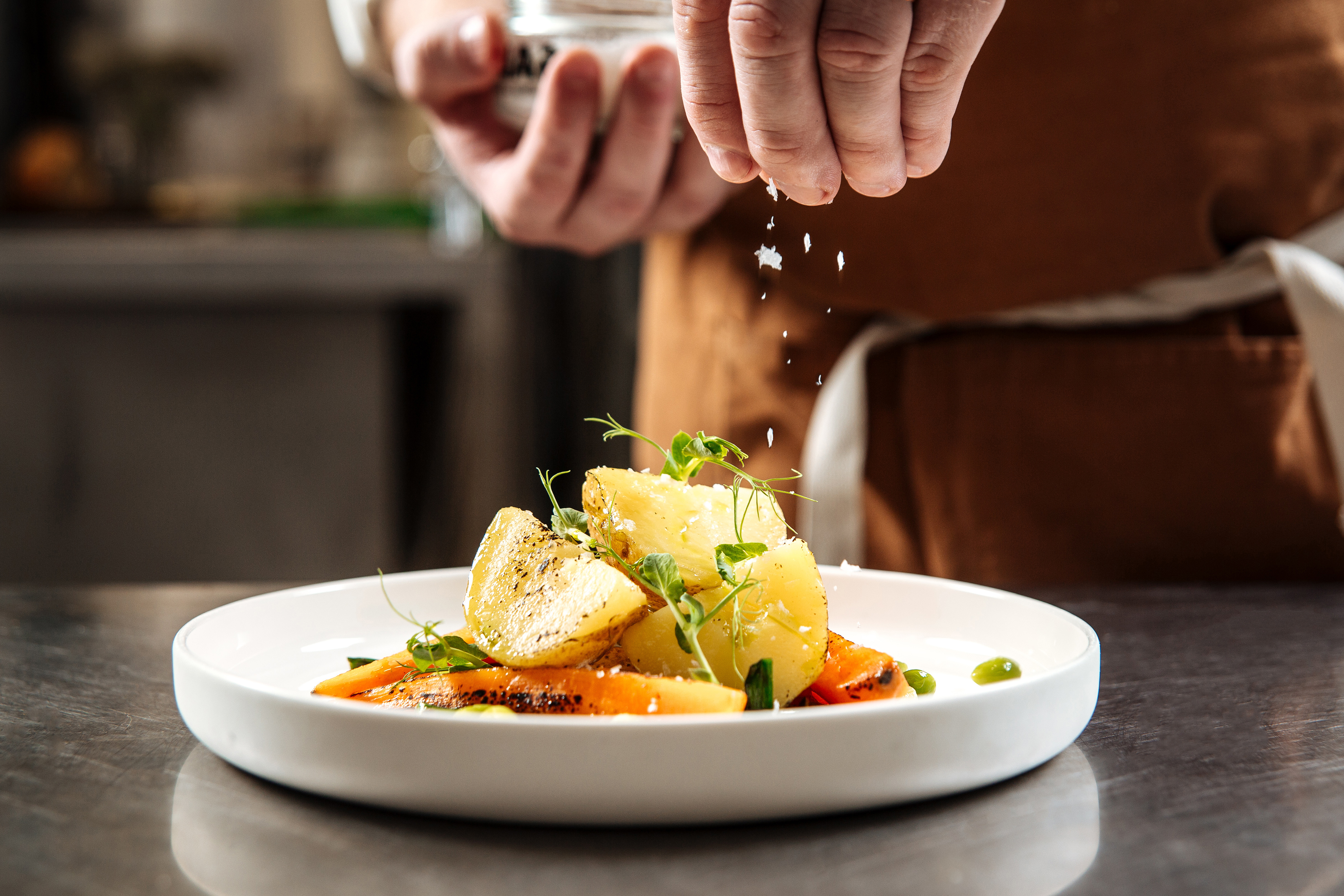 Chef plating food for a Heard Design brand experience